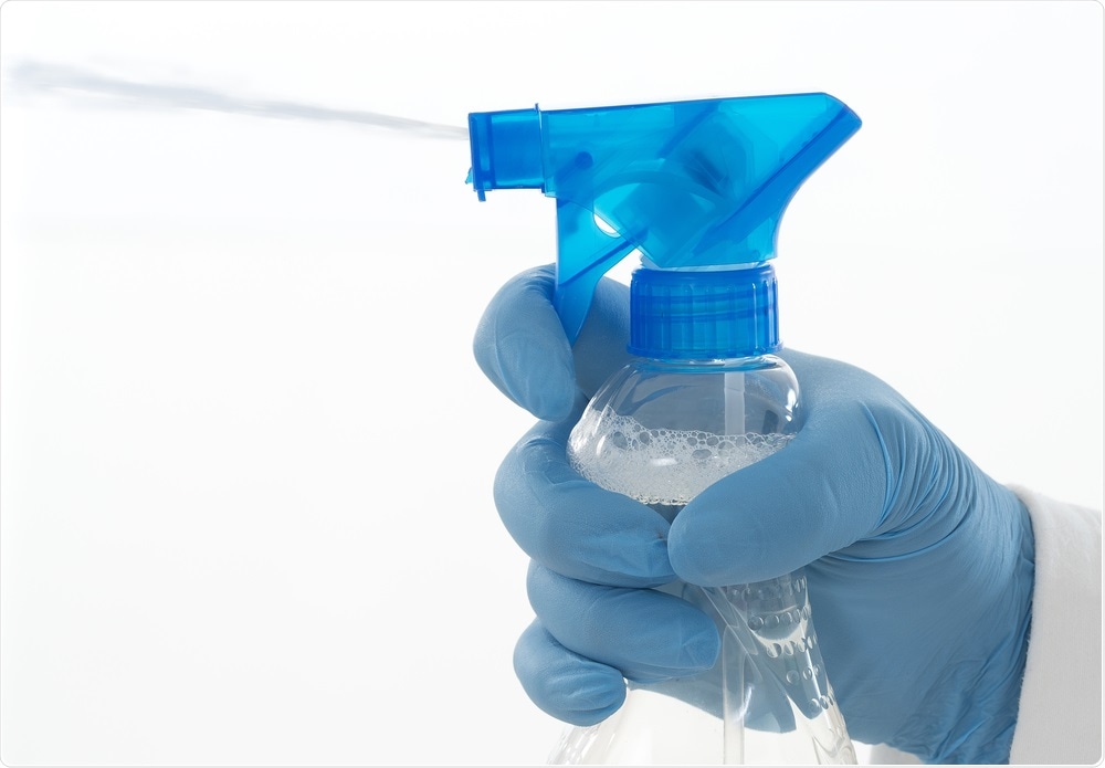 Person spraying disinfectant