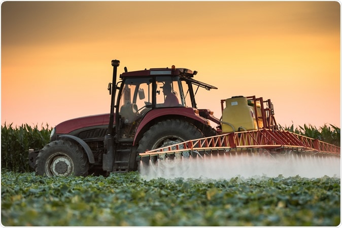 Tractor spraying pesticides. Image Credit: Fotokostic / Shutterstock