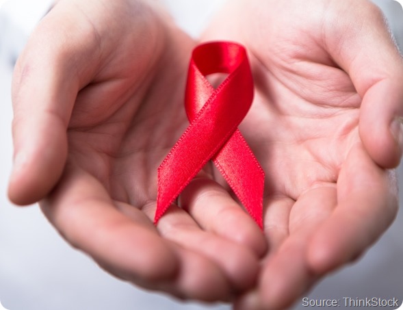 Man holding red aids ribbon