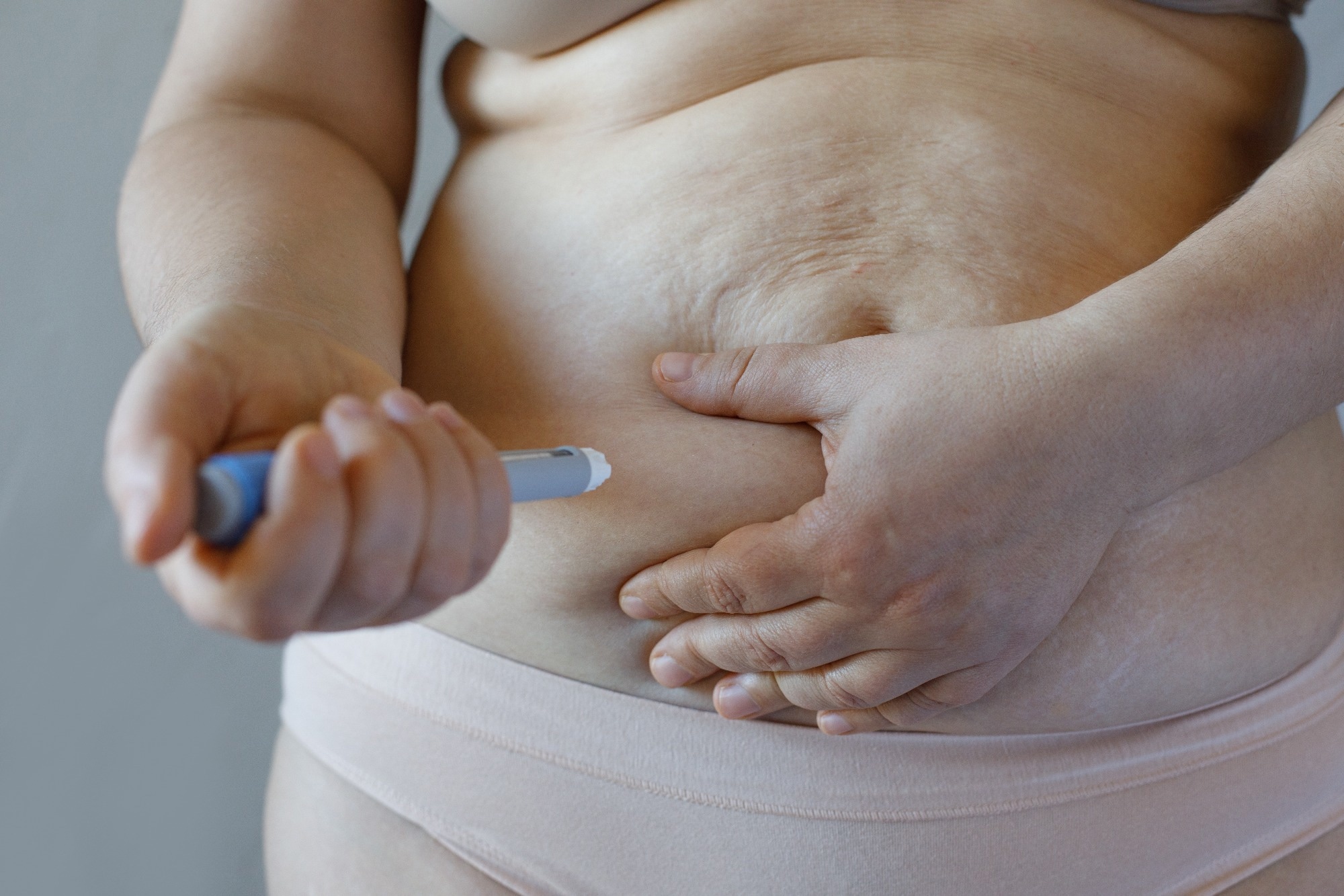 Semaglutide hormone used as a medication for improve blood sugar and weight loss. Injection pen and female body closeup.