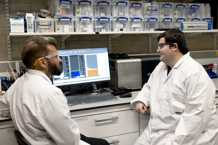 Two scientists from the Materials Group at the University of Birmingham analyzing results on a PC.