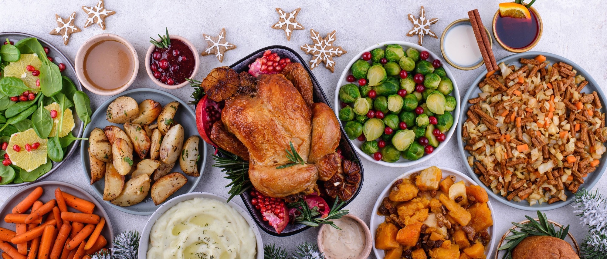A traditional Christmas dinner spread, with foods such as roast turkey, carrots, and gravy.