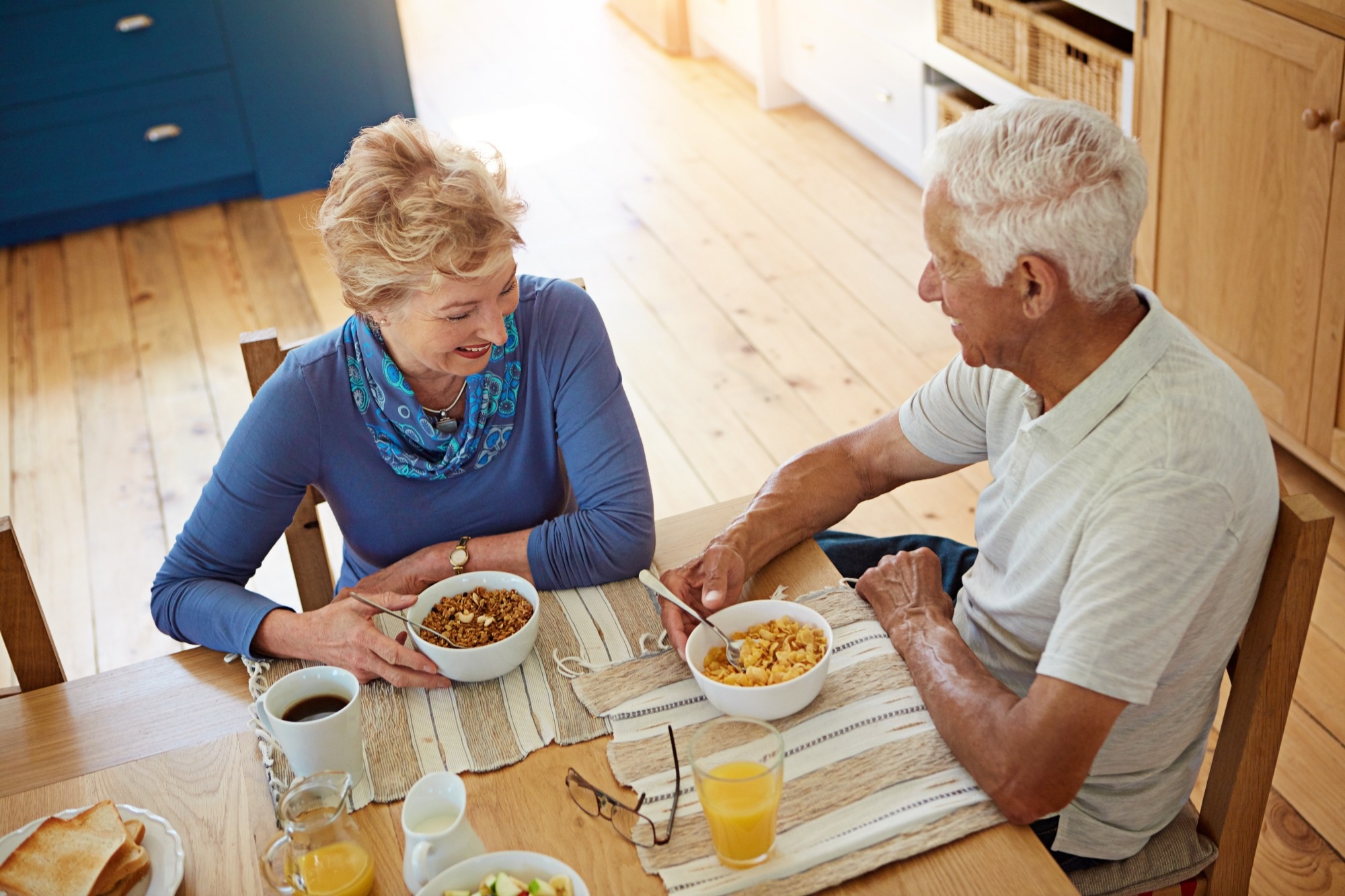 Elderly couple eating at breakfast in dining room