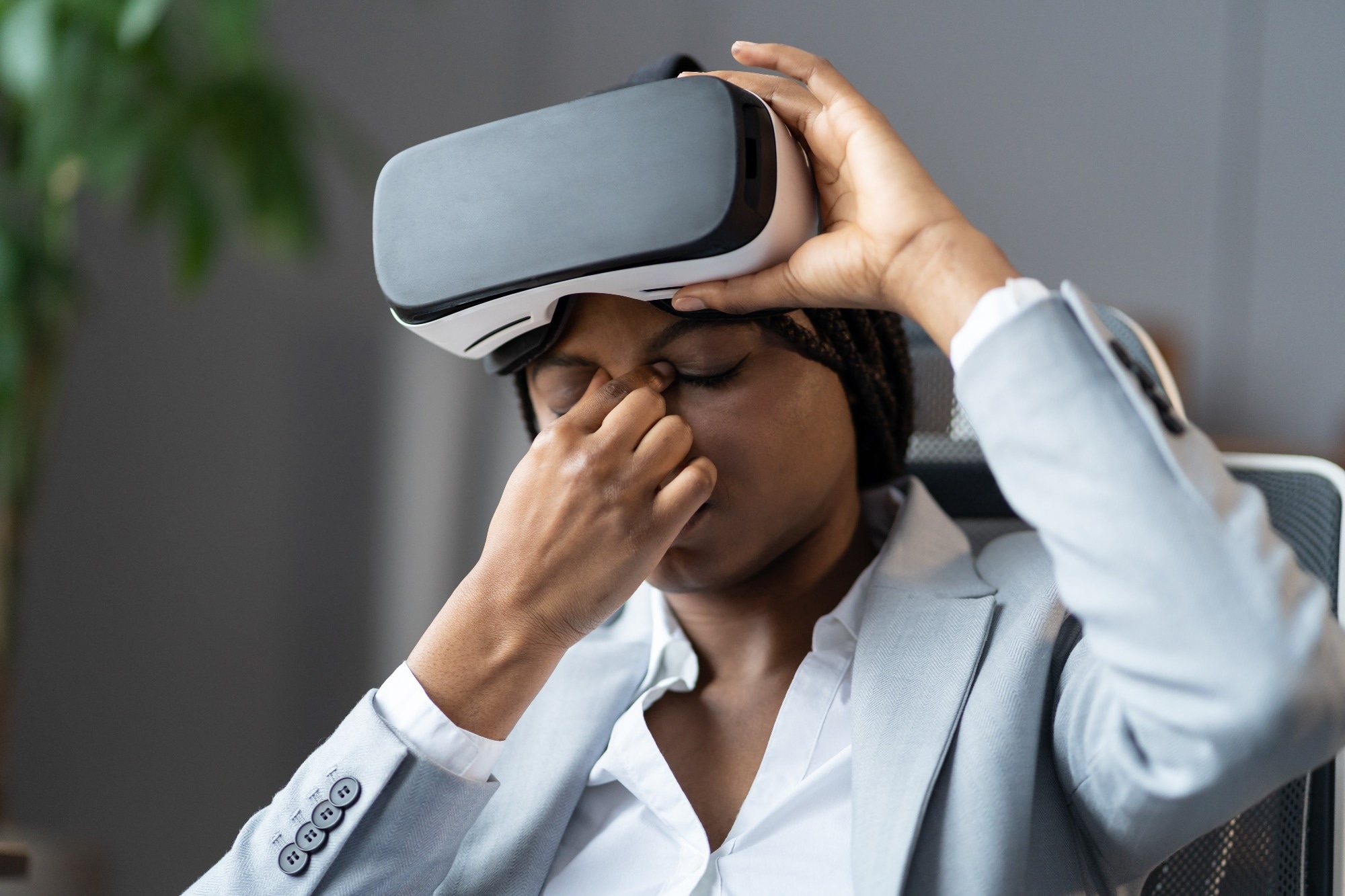 employee suffering from eye strain when using VR headset